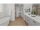 Elegant bathroom featuring a soaking tub, frameless glass shower, and double vanity sink at 9612 E Rainbow Ave, Mesa, AZ 85212