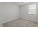 Bright bedroom with large window providing natural light, complete with carpet at 9612 E Rainbow Ave, Mesa, AZ 85212