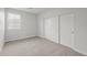 Neutral bedroom featuring carpet floors and closet with paneled sliding doors at 9612 E Rainbow Ave, Mesa, AZ 85212