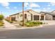 Inviting single-level house with stucco siding, tile roof, and simple, yet elegant landscaping at 9612 E Rainbow Ave, Mesa, AZ 85212