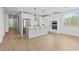 Modern white kitchen featuring stainless steel appliances, quartz countertops, and stylish pendant lighting at 9612 E Rainbow Ave, Mesa, AZ 85212