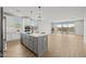 Bright open concept kitchen featuring island with modern appliances and outdoor view at 9612 E Rainbow Ave, Mesa, AZ 85212