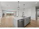 Kitchen island with stainless steel appliances and view of the backyard pool area through the sliding glass doors at 9612 E Rainbow Ave, Mesa, AZ 85212