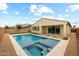 Gorgeous backyard pool and spa with travertine decking, and a synthetic grass border at 9612 E Rainbow Ave, Mesa, AZ 85212