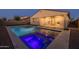 Backyard pool and spa with accent lighting, patio, and artificial turf enhance this home's outdoor living space at 9612 E Rainbow Ave, Mesa, AZ 85212