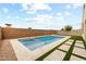 Stunning backyard pool and travertine decking with synthetic grass accents for a luxurious outdoor space at 9612 E Rainbow Ave, Mesa, AZ 85212