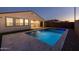 Backyard features a sparkling pool with a spa, travertine tile, and artificial turf at 9612 E Rainbow Ave, Mesa, AZ 85212