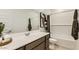 Bright bathroom featuring a clean white vanity, a large mirror, and modern fixtures at 9627 W Cheery Lynn Rd, Phoenix, AZ 85037