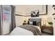 Well-lit bedroom with modern decor, stylish linens, and large window at 9627 W Cheery Lynn Rd, Phoenix, AZ 85037