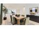 Bright dining room features modern decor, sleek furniture and a view into the adjacent living spaces at 9627 W Cheery Lynn Rd, Phoenix, AZ 85037