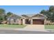 Inviting single-story home featuring a stone-accented facade, two-car garage, and well-manicured lawn at 9627 W Cheery Lynn Rd, Phoenix, AZ 85037