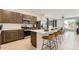 Modern kitchen with island seating, stainless steel appliances, and an open view to the living area at 9627 W Cheery Lynn Rd, Phoenix, AZ 85037