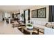 Open-concept living room boasts neutral tones, stylish furnishings, and seamless flow to the kitchen at 9627 W Cheery Lynn Rd, Phoenix, AZ 85037