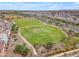This aerial showcases the community's wide, open green spaces and walking paths, offering recreational and leisurely opportunities at 9853 E Solstice Ave, Mesa, AZ 85212