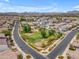 Gorgeous aerial view of a community park with playground, lush green space, and beautiful homes at 9853 E Solstice Ave, Mesa, AZ 85212