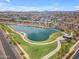 Stunning aerial view of a lake, green space, and homes in the surrounding community at 9853 E Solstice Ave, Mesa, AZ 85212