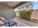 Relaxing outdoor patio area featuring a lounge set, colorful flowers, and privacy walls at 9853 E Solstice Ave, Mesa, AZ 85212