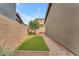 Backyard featuring artificial grass, pavers, gravel and block fence at 9853 E Solstice Ave, Mesa, AZ 85212