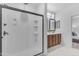 Modern walk-in shower offers sleek fixtures and bright lighting, adjacent to the bathroom's vanity at 9853 E Solstice Ave, Mesa, AZ 85212