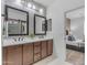 Bathroom with a double sink vanity, sleek fixtures, and easy access to the adjacent stylish bedroom at 9853 E Solstice Ave, Mesa, AZ 85212