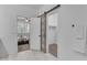 Bright bathroom with a sliding door to walk-in closet and view into bedroom at 9853 E Solstice Ave, Mesa, AZ 85212