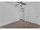 A standard bedroom with neutral carpet, ceiling fan, and sliding door closet at 9853 E Solstice Ave, Mesa, AZ 85212