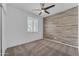 Bedroom featuring neutral carpet, accent wall, ceiling fan, and plantation shutters at 9853 E Solstice Ave, Mesa, AZ 85212