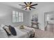 Well-lit bedroom featuring a ceiling fan, plantation shutters, and sophisticated decor creating a relaxing atmosphere at 9853 E Solstice Ave, Mesa, AZ 85212