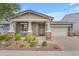Charming single-story home featuring a large driveway, two-car garage, and meticulously landscaped front yard at 9853 E Solstice Ave, Mesa, AZ 85212
