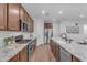 Well-appointed kitchen with stainless appliances, granite countertops, and a functional layout at 9853 E Solstice Ave, Mesa, AZ 85212
