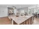 Spacious kitchen island featuring granite countertops, stylish seating, and an open view to the living area at 9853 E Solstice Ave, Mesa, AZ 85212
