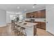 Stylish kitchen island with barstool seating and granite counters, connecting seamlessly to the dining area at 9853 E Solstice Ave, Mesa, AZ 85212