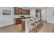 Stylish kitchen featuring granite countertops, wood flooring, stainless appliances, and island with seating at 9853 E Solstice Ave, Mesa, AZ 85212