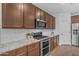 Modern kitchen featuring granite countertops, stainless steel appliances, and ample cabinet space at 9853 E Solstice Ave, Mesa, AZ 85212