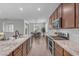 Bright open-concept kitchen offering granite countertops, stainless steel appliances, and seamless flow to dining area at 9853 E Solstice Ave, Mesa, AZ 85212