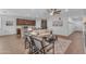 Open-concept living space with cozy seating, wood-look flooring, and a seamless flow to the kitchen at 9853 E Solstice Ave, Mesa, AZ 85212