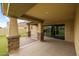 View of the back patio that features stone pillars and overlooks the artificial grass backyard at 9911 E Telemetry Dr, Mesa, AZ 85212