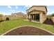 Lush backyard featuring artificial grass, desert landscaping and a covered patio at 9911 E Telemetry Dr, Mesa, AZ 85212