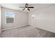 Inviting bedroom with a ceiling fan and a walk-in closet, with large windows offering ample natural light at 9911 E Telemetry Dr, Mesa, AZ 85212