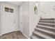 Bright entryway featuring wood-look floors, stairs with carpet and decorative alcove at 9911 E Telemetry Dr, Mesa, AZ 85212
