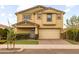 Two-story home features attached two car garage, stucco facade, and manicured front yard at 9911 E Telemetry Dr, Mesa, AZ 85212