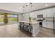 Bright open kitchen featuring a large island with seating, stainless appliances, and tile flooring at 9911 E Telemetry Dr, Mesa, AZ 85212