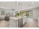 Kitchen island with stainless steel dishwasher, undermount sink, granite counters, and pendant lights at 9911 E Telemetry Dr, Mesa, AZ 85212
