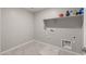 A functional laundry room with tile flooring, a utility sink, and built-in shelving at 9911 E Telemetry Dr, Mesa, AZ 85212