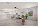 Bright living room features a ceiling fan, stylish seating, and large windows for natural light at 9911 E Telemetry Dr, Mesa, AZ 85212