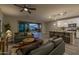 Open living room flows into the kitchen with access to the backyard through sliding glass doors at 9911 E Telemetry Dr, Mesa, AZ 85212