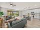 Open-concept living room showcases sliding glass doors and is adjacent to the kitchen island with pendant lighting at 9911 E Telemetry Dr, Mesa, AZ 85212