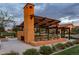 Community outdoor fireplace and ramada provides seating and shade amongst beautifully landscaped surroundings at 9911 E Telemetry Dr, Mesa, AZ 85212