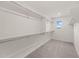 Spacious walk-in closet featuring carpet flooring, shelving, and a window for natural light at 9911 E Telemetry Dr, Mesa, AZ 85212
