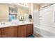 Bathroom featuring double sink vanity, framed mirror, soaking tub and lots of counter space at 10 N 87Th Dr, Tolleson, AZ 85353